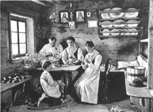 family of wood-carvers at Selva in the Gardena Valley making wooden toys, about 1920